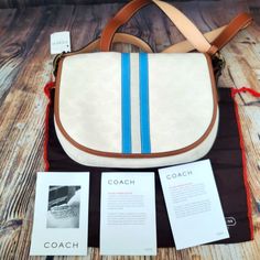 Coach Ivory Canvas Signature Bag New With Tags. Dust Bag And Care Card Included. Color: Ivory, Blue Middle Stripe And Brown Leather Trim. 1 Interior Zip Pocket. 1 Back Slip Picket. 9 1/2" Width X 10 1/2" High Feel Free To Visit My Page Or Follow Me To See Other Items On Sale. G449 Pink Coach Purses, Navy Crossbody Bag, Ashley Black, Coach Crossbody, Buckle Bags, Black Leather Crossbody Bag, Signature Canvas, Vintage Coach, Leather Buckle