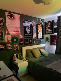 a bedroom with posters on the wall and a bed