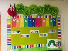 the very hungry caterpillar bulletin board is decorated with green paper and red flowers