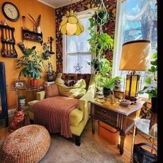 a living room filled with furniture and lots of plants on the wall next to a window