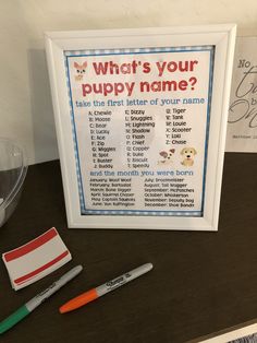 there is a sign that says what's your puppy name? and two markers next to it