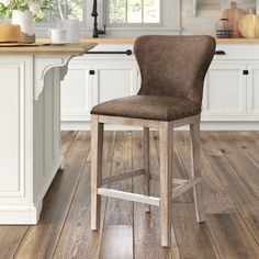 a brown leather bar stool in a kitchen