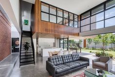 a living room filled with furniture and lots of windows