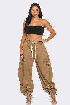 These pants feature a relaxed, oversized fit with an adjustable drawstring waist and cuffs for a customizable look. Crafted from high-quality denim, they provide both comfort and durability. The unique cargo-style pockets add functionality and a trendy, streetwear-inspired vibe. Perfect for pairing with a crop top and heels or a casual tee and sneakers, these versatile pants will make a bold statement in any outfit. Experience the perfect blend of style and utility with the Urban Chic Drawstring Khaki Cargo Jeans With Elastic Waistband, Utility Style Cotton Cargo Jeans With Elastic Waistband, Utility Cotton Cargo Jeans With Elastic Waistband, Baggy Utility Cargo Jeans With Elastic Waistband, Wide Leg Cotton Cargo Jeans For Outdoor, High Waist Brown Cotton Parachute Pants, High-waisted Brown Cotton Parachute Pants, Hip Hop Cotton Cargo Jeans, Hip Hop High Waist Cotton Cargo Pants