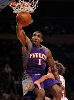 a man dunking a basketball in the air