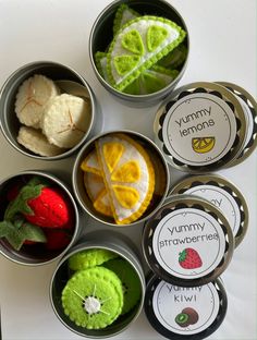 six small tins filled with different types of fruits and veggies in them