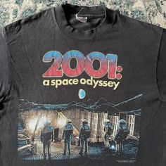 a black t - shirt with the words 2000 as space odyssey printed on it