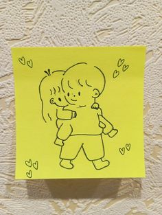 a yellow post - it note with a drawing of two children hugging each other and hearts on the wall