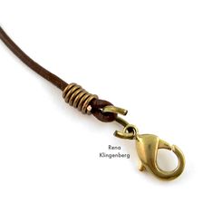 a brown cord with a brass clasp on it