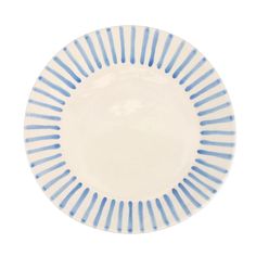 a blue and white plate with stripes on it's rim, against a white background