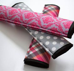 two pink and gray polka dot umbrellas on top of each other with black trim