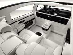 the interior of a car with all white leather and black trims, including center console