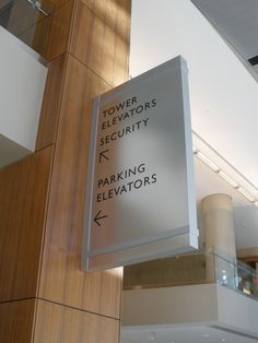 a sign hanging from the side of a building that says tower elevators security parking elevators