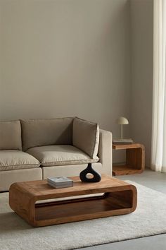 a living room with a couch, coffee table and two end tables on carpeted flooring