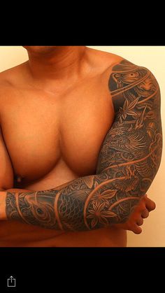 a man with tattoos on his arms and chest