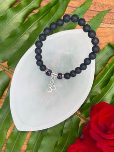 Introducing our 7 Chakras Onyx Bracelet Series! This bracelet is intended to activate the 6th Chakra, also known as the Third Eye Chakra, our bodies' energy center for Intuition and Vision. Amethyst activates spiritual awareness & wisdom, opens intuition and enhances psychic abilities. Said to guard against psychic attack, Amethyst calms and stimulates the mind, helping with focus and motivation. The stone also assists with dream recall, mood swings, anger, rage and fear. Amethyst has also been Black Spiritual Beaded Bracelets For Meditation, Spiritual Black Stretch Bracelet For Healing, Adjustable Spiritual Charm Bracelet For Meditation, Black Spiritual Crystal Bracelet As Gift, Spiritual Black Crystal Bracelet As A Gift, Spiritual Adjustable Hypoallergenic Charm Bracelet, Spiritual Black Crystal Bracelet Gift, Spiritual Hypoallergenic Adjustable Charm Bracelet, Adjustable Black Stretch Bracelet For Meditation