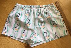 "Horses/Horseshoe theme on green and white striped background flannel sleep shorts 100% cotton flannel Enclosed elastic waistband with 1/2\" non-roll elastic Low rise Side seams 2\" inseam on all sizes Hip sizing: XS(32-34\"), S(35-37\"), M(38-40\"), L(41-43\") Front rise: XS(9 3/4\"), S(10 1/2\"), M(11 1/2\"), L(12 3/4\") Back rise: XS(13 1/2\"), S(14 1/2\"), M(16\"), L(16 3/4\") Measurements are approximate Sizing allows for about 2-3 inches of ease/shorts run a size smaller than the pants All Cute Cotton Pajama Shorts With Elastic Waistband, Green Cotton Pajama Shorts, Green Relaxed Fit Cotton Pajama Shorts, Green Cotton Pajama Shorts With Elastic Waistband, Green Pajama Shorts For Summer Sleepover, Green Pajama Shorts For Spring Sleepover, Cute Cotton Sleep Shorts, Cute Green Cotton Sleepwear, Green Summer Pajama Shorts For Bedtime