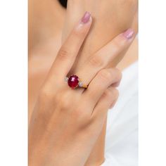 This is part of Chairish’s Fine Jewelry assortment.  Oval Cut Ruby Cocktail ring in 18K Gold which perfectly goes with your personality and also helps you to improve your energy and sensuality. Designed with big oval cut ruby in center and halo of clustered diamonds both side that makes it a perfect fit to wear it on your wedding or style it with any of your basic outfit to give it a glam.  PRODUCT DETAILS :-  > Material - 18K Solid Yellow Gold > Gemstone - Ruby > Gemstone Weight - 2.92 ct > Gemstone pcs - 1  > Gemstone shape - Oval  > Gemstone size - 12 x 9 mm > Diamond weight - 0.25 ct > Diamond Size - 1.5 mm > Diamond pcs - 14  > Gross Weight - 5.494 Grm > Shank width - 2 mm > Setting - Pinion Bezel setting Red Oval Diamond Ring, Luxury Oval Ruby Birthstone Ring, Luxury Oval Ruby Ring With Gemstone, Oval Lab-created Ruby Rings For Formal Events, Luxury Ruby Ring With Oval Center Stone, Elegant Ruby Rings With Oval Cabochon Center Stone, Luxury Oval Ruby Ring With Center Stone, Oval Ruby Diamond Ring, Oval Ruby Ring With Prong Setting For Proposal