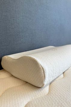 a close up view of the side of a bed with a memory pillow on it