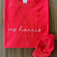 a red t - shirt with the word no matter on it next to a pair of shoes