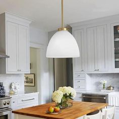 a kitchen with white cabinets and an island