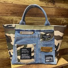 a handbag made out of jeans and camo