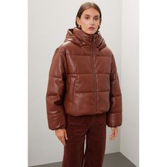 Brown faux leather (100% Polyurethane). Lining (100% Polyester). Puffer. Long sleeves. High neck. Front zipper closure. 23" from shoulder to hemline. Imported. Chic Puffer Jacket For Workwear In Fall, Winter Faux Leather Jacket With Zipper Closure, Chic Fall Puffer Jacket For Workwear, Leather Puffer Jacket With Zipper For Fall, Fall Puffer Leather Jacket For Work, Chic Puffer Leather Jacket For Work, Leather Puffer Outerwear For Work, Leather Puffer Jacket For Winter, Spring Puffer Leather Jacket For Work