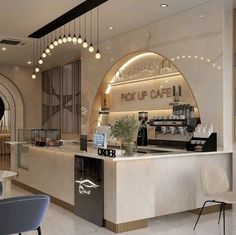 the interior of a coffee shop with an arched ceiling and white marble counter top, along with blue chairs