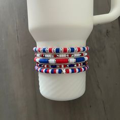 A fun collection of red, white, and blue beaded bracelets hand crafted to add personal style to your Stanley cup.  🌟 Great for gift giving, holidays, sports, parties, and everyday charm. 🌟 Set includes 5 bracelets designed to fit the 40oz Stanley Quencher with a silicone boot in place.  🌟 Variations: 3 Bracelet Stack https://tinebirddesigns.etsy.com/listing/1719875918 4 Bracelet Stack https://tinebirddesigns.etsy.com/listing/1734070961 Tips & Care: - Will also fit the 20oz and 30oz Stanley cu Adjustable White Patriotic Beaded Bracelets, Patriotic Red Beaded Bracelets, Casual Blue Bracelets For 4th Of July, Casual Multicolor Bracelets For 4th Of July, Adjustable Red Beaded Bracelets For 4th Of July, Red Beaded Bracelets For 4th Of July, Adjustable White Beaded Bracelets For 4th Of July, Patriotic Red Adjustable Beaded Bracelet, Handmade Patriotic White Beaded Bracelets