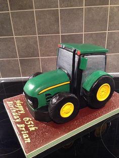 a green tractor cake sitting on top of a table