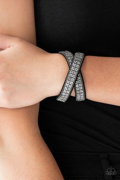 Infused with dainty gunmetal ball chain, glittery hematite rhinestones are sprinkled across a black suede band in a cube like pattern for an edgy look. The elongated band allows for a trendy double wrap design. Features an adjustable snap closure.

Sold as one individual bracelet. Double Wrap Bracelet, Snap Bracelets, Black Rock, Black Bracelets, Paparazzi Accessories, Edgy Look, Affordable Jewelry, Paparazzi Jewelry, Rock Band