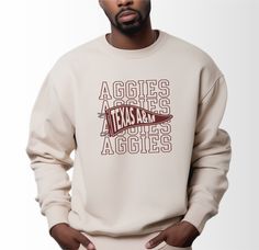 Embrace the comfort of Aggie tradition with our Texas A&M Aggies Pennant Crewneck Sweatshirt! Blending premium polyester and cotton, it's a testament to both durability and softness. Whether you're exploring the heart of College Station or catching the latest game at Reed Arena, its plush feel keeps you cozy while its ribbed knit collar adds a touch of style. Plus, with its seamless construction, you'll experience unparalleled comfort without those pesky itchy side seams. Show your Aggie pride i Vintage College Apparel, College Merch Ideas, Spiritwear Designs, Collegiate Design, Spirit Wear Designs, Aggie Pride, Kyle Field