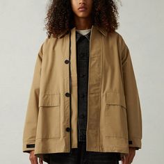 The Essentials Fear Of God Oak Barn Jacket Features Long Sleeves, An Oversized Collar, Cargo Flap Pockets At The Front, A Full Zipper Front Closure, And A Rubber Brand Label On The Sleeve Hems And Upper Back. Solid Color Barn Jacket Collar Long Sleeves Cargo Flap Pockets Zipper Front Closure Button-Down Front Rubber Brand Labels Oversized Fit Never Been Worn. Lighting When It’s Spread Out Makes It Look Lighter Oversized Gabardine Outerwear With Pockets, Brown Relaxed Fit Outerwear For Work, Winter Utility Gabardine Outerwear, Beige Single Breasted Utility Outerwear, Beige Oversized Utility Outerwear, Khaki Long Sleeve Gabardine Outerwear, Khaki Gabardine Outerwear, Khaki Gabardine Long Sleeve Outerwear, Oversized Single Breasted Utility Outerwear