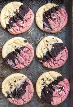 cookies with chocolate and pink frosting on a baking sheet, ready to go into the oven