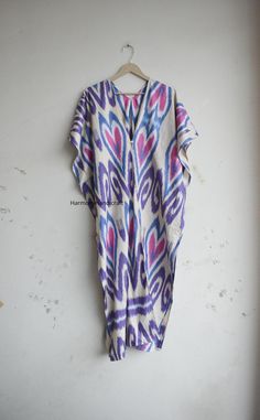 This Cotton ikkat Kaftan Is made From incredibly soft and lightweight cotton and is versatile for many occasions. It is so free flowing that it will make you feel as you are not wearing anything at all. The beauty of Front open kaftan is that they will fit everyone. You can wear it as a kaftan and kimono also.  The perfect floral print Kaftan is used to Lounge Wear, Resort Wear, Party Dress, beach Cover up, House Working Dress and use for a dinner party or just slip into in on a beautiful summer Multicolor Ikat Print Kaftan Tunic, Multicolor V-neck Kaftan With Batik Print, Multicolor Ikat Print Long Sleeve Kaftan, Long Sleeve Multicolor Ikat Print Kaftan, Multicolor Long Sleeve Ikat Print Kaftan, Bohemian Multicolor V-neck Thobe, Patterned Kaftan With Kimono Sleeves For Festival, Festival Patterned Kaftan With Kimono Sleeves, Long Patterned Kaftan For Festival