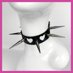 Spread the love with this unique choker, handmade with a PVC vinyl strap featuring adorable heart cut aways and shiny spikes for that extra edge.  Size: 31 - 40cm Features: Thick black vinyl strap with heart shaped holes.  5cm long spikes.  Steel (some nickel plated) hardware. Spiked Choker For Concerts, Concert Choker With Spikes, Spiked Choker For Concert, Edgy Metal Choker For Valentine's Day, Edgy Heart-shaped Choker For Concerts, Punk Spikes Choker For Party, Punk Spiked Choker For Parties, Edgy Spiked Choker For Party, Adjustable Punk Heart Choker