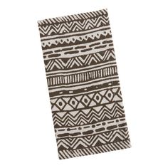 a brown and white towel on top of a white surface with an abstract design in the middle