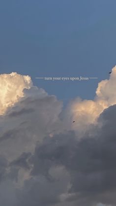 an airplane is flying in the sky with some clouds behind it that says turn your eyes upon jesus