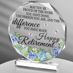 a clear glass award with blue and green flowers on the bottom that says, may you be proud of the work you have done