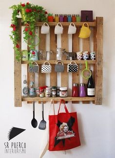 a wooden shelf filled with pots and pans next to a wall mounted pot rack