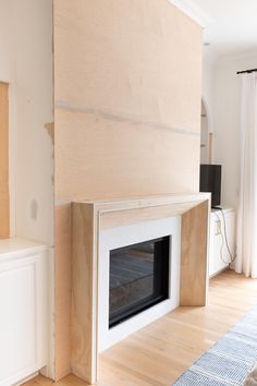 an unfinished fireplace in the middle of a living room