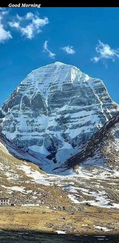 the mountain is covered in snow and clouds