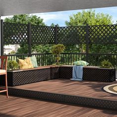 an outdoor deck with chairs, table and rugs on the wooden flooring area