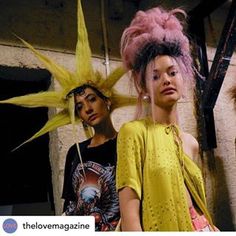 two young women standing next to each other with hair on their head and one wearing a yellow dress