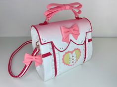 This is a pre-order and expected to arrive to you by September 2021. Inspired by the magical girl Madoka, this bag is the epitome of lovely. This top handle satchel is soft to the touch and features twin magnetic openings can carry your iPad, any size iPhone, and various items such as your switch (regular version). The Magical Girl Madoka, Whimsical Goth, Heart Pocket, Vegan Leather Bag, Madoka Magica, Cute Bags, Rose Gold Color, Magical Girl, Alternative Fashion