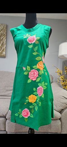 Adorned in a stunning hand-painted green dress, embellished with beautifulflowers. This dress exudes elegance and charm, perfect for any occasion Green Floral Dresses For Summer, Green Flower Dress For Garden Party, Green Cotton Floral Dress For Garden Party, Elegant Green Dress With Floral Embroidery, Green Floral Dress For Garden Party, Green Floral Print Embroidered Dress For Spring, Green Embroidered Floral Dress For Spring, Green Floral Applique Dress For Summer, Spring Green Embroidered Dress