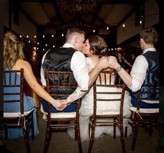 a bride and groom kissing at their wedding reception