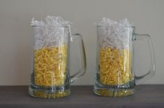 two glass mugs filled with rice and corn