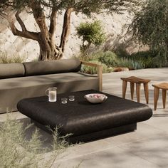 an outdoor seating area with coffee table and stools