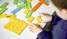 a child is playing with lego blocks on the table